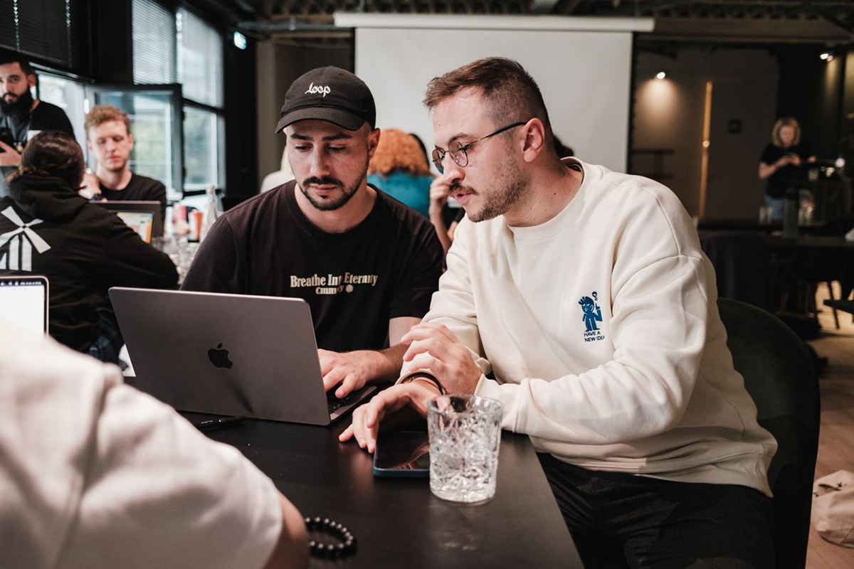 Colleagues reviewing work together at one screen