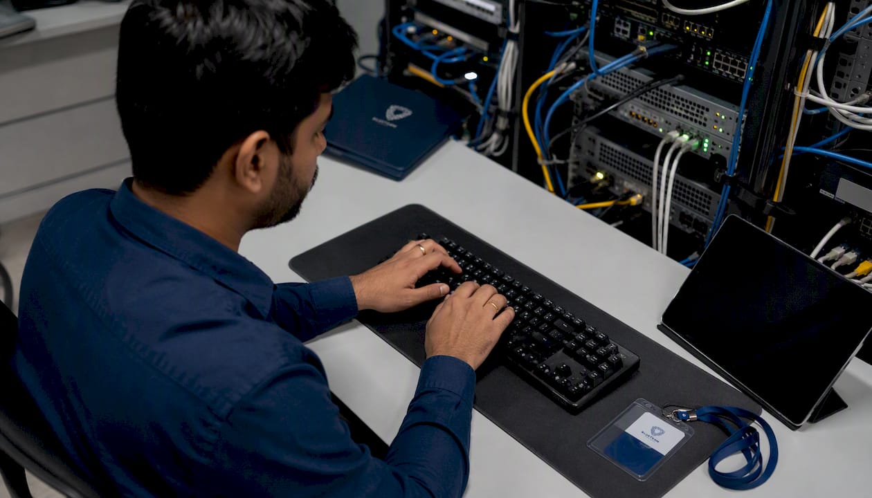Hands typing in cybersecurity lab workspace