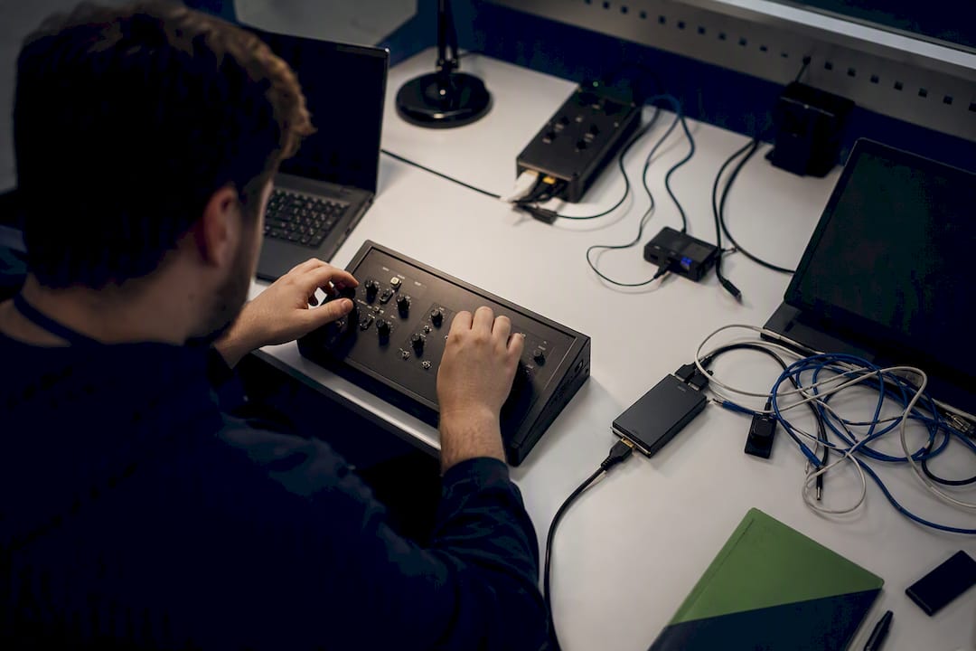 Hands operating cybersecurity lab control panel