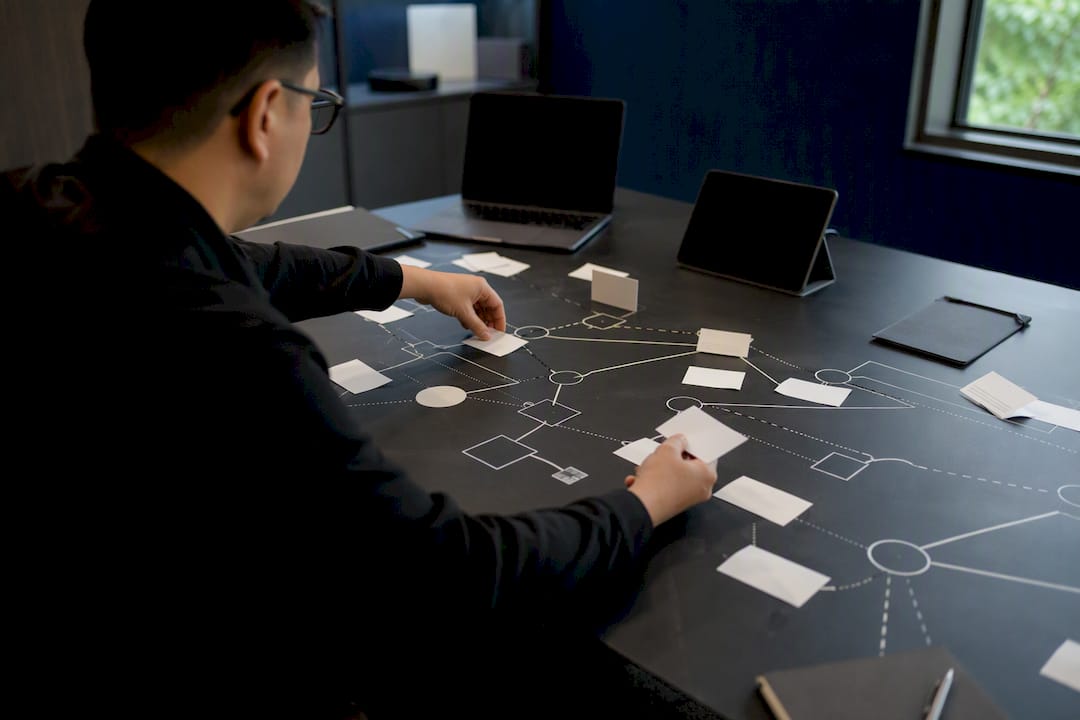 Hands setting up tabletop cybersecurity exercise