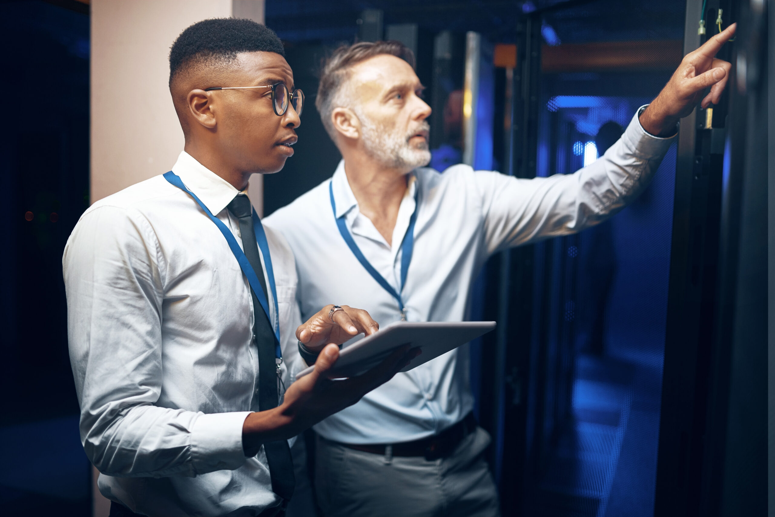 Inspection, engineer or men with tablet in server room, system backup process or cybersecurity update. Pointing, firewall testing or people with mainframe assessment, tech or data center maintenance